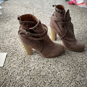 Tan heeled booties. They are worn, but with only a few scuffs and marks.